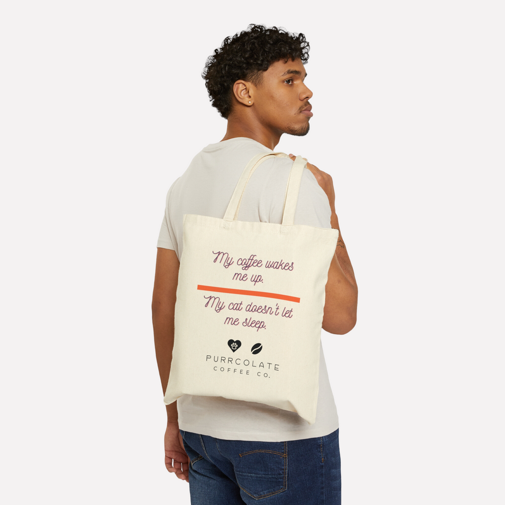 Man holding a Purrcolate tote bag over his shoulder